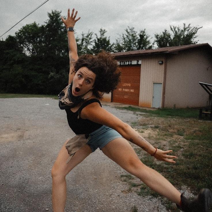 Avery Singh, Lead Design Curator at Azure Meander Summer, reviewing corporate floral arrangements